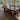 Wooden Whale Workshop Harmony Leg Dining Table showing smooth wooden surface and sturdy legs in a well-lit room.