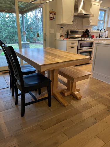 Wooden Whale Workshop Terresa Style Dining Table showing smooth wooden surface and sturdy legs in a modern dining room setting.