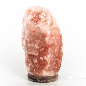 Authentic Himalayan salt lamp from Black Tai Salt Co., 15-20 lbs, showing its natural pink-orange salt crystal glow.