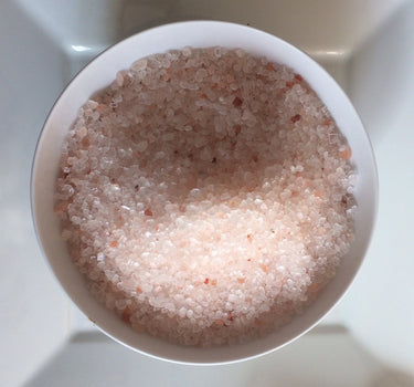 Coarse Himalayan salt in 55lbs bag, peppercorn size, from Black Tai Salt Co., for culinary and seasoning use.