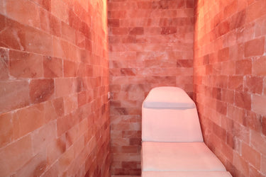 Himalayan Salt Room sauna by Black Tai Salt Co. with 8x8 ft surface area, featuring pink salt walls and cozy interior.