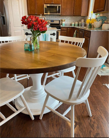 Wooden Whale Workshop tulip round table with smooth wooden surface and sturdy base, perfect for dining or casual use.