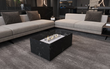 Black marble coffee table with built-in fireplace by MEG Custom Marble, featuring sleek design and elegant marble surface.
