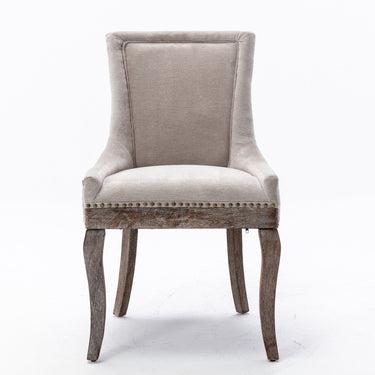 Set of two beige A&A Furniture Ultra Side Dining Chairs with thick fabric and bronze nail head accents.