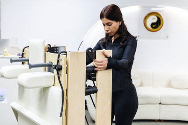 Personal Hour Janet Elite 2.0 foldable Pilates reformer machine for full-body workouts, shown in a studio setting.