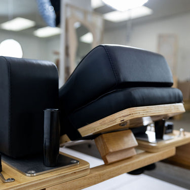 Personal Hour Pilates head and neck support pillow for yoga and Pilates, with ergonomic design and soft fabric cover.