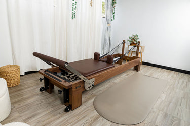 Nano La Force Plus Premium Walnut Studio Reformer Pilates machine by Personal Hour, featuring a sleek wooden frame and adjustable resistance.