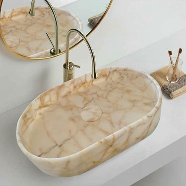 Luvohome Calacatta Gold marble above-vanity oval curved sink in polished natural stone, 16x24 inches with 5-inch height in a bathroom scene.