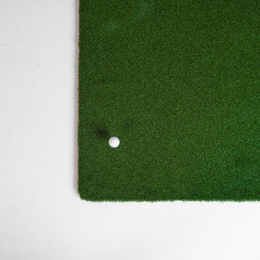 GolfbaysUSA golf hitting mat with insert tee, measuring 4'11" x 4'11", showing the textured surface and tee holder.