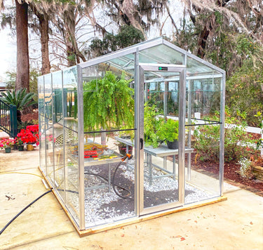 Janco greenhouse 8x10 Palmetto Greenhouse with transparent panels and sturdy frame for gardening and plant protection.