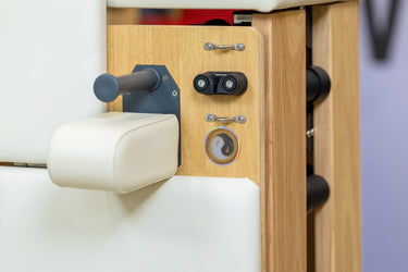 Foldable Zous Pro Pilates Reformer by Personal Hour with adjustable straps and padded carriage, compact design for versatile workouts.