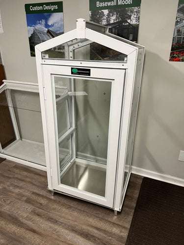 Janco greenhouse indoor/outdoor garden cabinet with transparent door and shelving for plant storage and gardening tools.