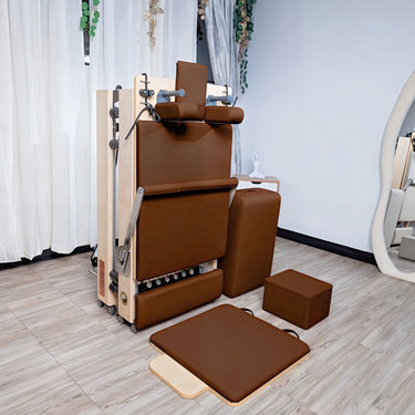 Personal Hour Janet Elite 2.0 foldable Pilates reformer machine with adjustable straps and cushioned carriage for versatile workouts.