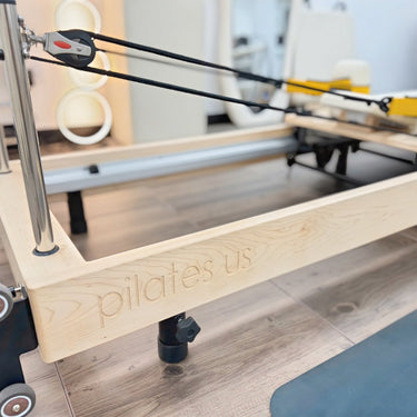 Personal Hour Janet Elite Plus foldable Pilates Reformer with padded carriage, adjustable resistance, and compact design for home workouts.