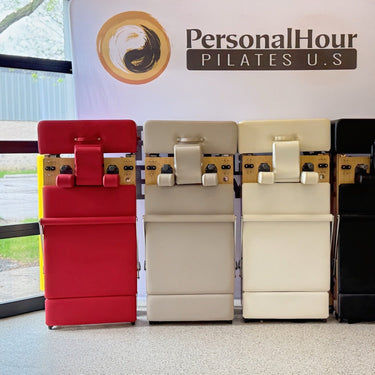 Foldable Zous Pro Pilates Reformer machine by Personal Hour, showing adjustable straps and compact design for versatile workouts.