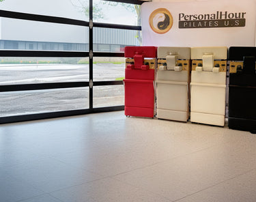 Foldable Zous Pro Pilates Reformer by Personal Hour with adjustable straps and cushioned platform for versatile exercise routines.