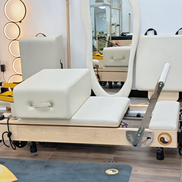 Personal Hour Janet Elite Plus foldable Pilates Reformer machine with adjustable resistance and cushioned carriage for effective workouts.