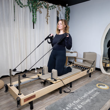 Personal Hour Janet Elite 2.0 foldable Pilates reformer with padded carriage and adjustable resistance for low-impact exercise.