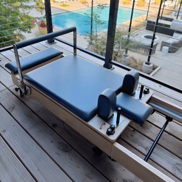 Personal Hour Janet Elite Plus foldable Pilates reformer with padded carriage, adjustable straps, and compact design for versatile workouts.