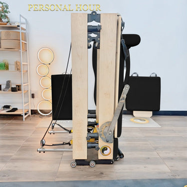 Black Janet Elite Plus foldable Pilates Reformer by Personal Hour, a versatile Pilates machine with adjustable features.