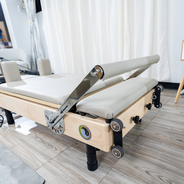 Foot bar attachment for Janet Elite 2.0 foldable Pilates Reformer by Personal Hour, showing the adjustable foot support.