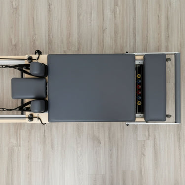 Personal Hour Janet Elite Plus foldable Pilates Reformer machine with adjustable springs and padded carriage for full-body workouts.