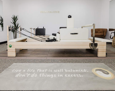 Large Nano Elite Plus Pilates Reformer by Personal Hour featuring a sturdy frame, adjustable straps, and a cushioned carriage for exercise.