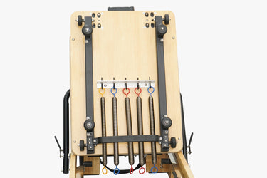 Pink Nano Pro Lite Pilates Reformer by Personal Hour, compact Pilates machine with adjustable resistance for full-body workouts.