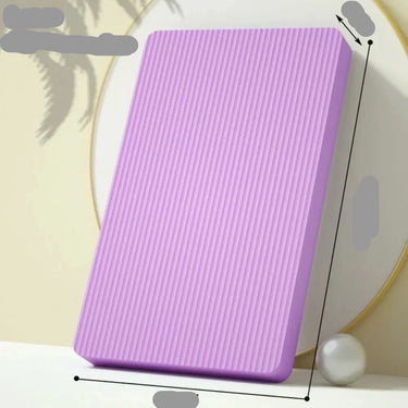Anti-slip balance pad with knee cushions for yoga and fitness exercises, featuring a textured surface and cushioned support.