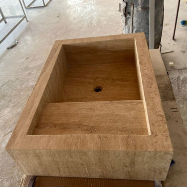 Handcrafted custom travertine kitchen sink by Luvohome, featuring a natural textured surface and durable design.