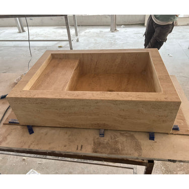 Handcrafted custom travertine kitchen sink by Luvohome featuring a smooth, natural stone finish with elegant design.