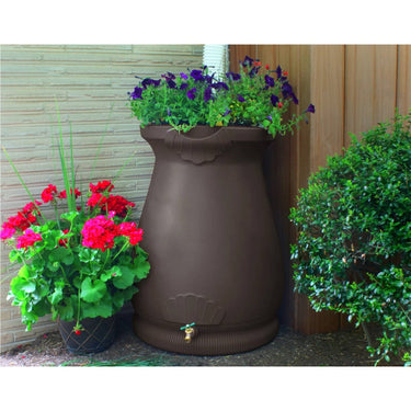 Brown oak 65-gallon plastic rain barrel with planter top for outdoor gardening, suitable for rain collection and decorative planting.
