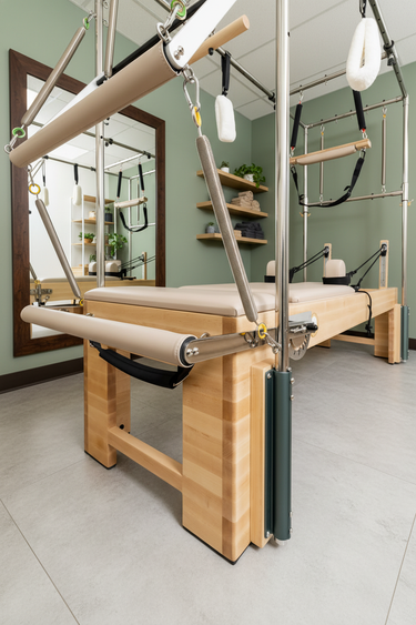 Personal Hour Napolie Clinical Plus Cadillac and Pilates Reformer machine for Pilates exercises, featuring adjustable components and sturdy frame.