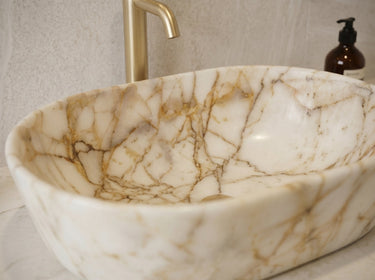 Luvohome Calacatta Gold marble above-vanity oval curved sink, polished natural stone with white and gold veining, 16x24 inches.