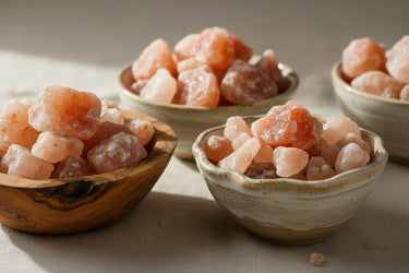 Black Tai Salt Co. Himalayan Salt Chunks in bowls, 1-3 inches, showcasing natural pink and orange mineral textures for culinary and decor use.