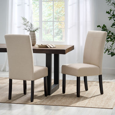 Contemporary Pertica dining side chair by HouseOfZazla with natural wood frame and fabric upholstered seat and back.