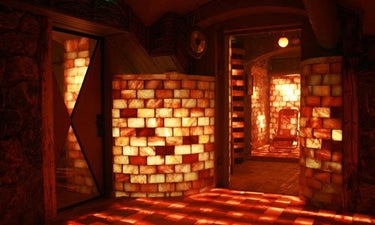 Black Tai Salt Co. Himalayan Salt Sauna room, 16x16 feet, surface area 256 sq feet, with salt walls and cozy interior.