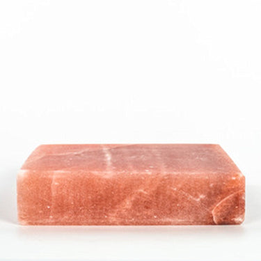 Himalayan salt room with black Tai Salt Co. salt bricks, 4x4 feet surface area, showcasing pink and orange salt plates arranged inside.