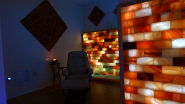 Himalayan salt room with black Tai Salt Co. salt bricks and plates, covering 16 sq feet for a calming, natural salt therapy space.