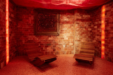 Himalayan salt room with 16 sq ft surface area, black Tai Salt Co. salt bricks and plates, 8x8x2 inch salt blocks arranged in the room