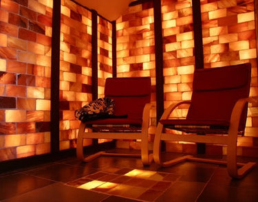 Himalayan Salt Sauna by Black Tai Salt Co. with 8' x 4' surface area, showcasing salt blocks and sauna interior design.