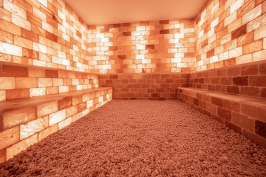 Himalayan salt sauna with Black Tai Salt Co. salt bricks and plates, showcasing a 4x4-foot surface area in a spa setting