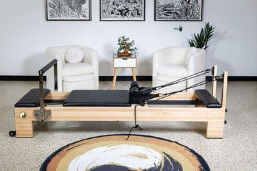 Large Nano Elite Plus Pilates Reformer by Personal Hour, a premium studio Pilates machine with adjustable features and cushioned surfaces.