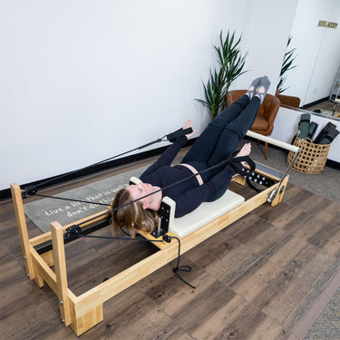Nano Pro Lite Pilates Reformer by Personal Hour, compact Pilates machine with adjustable resistance and padded carriage in a lifestyle setting.