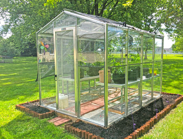 Janco greenhouse Palmetto 8' x 10' greenhouse with transparent panels and sturdy metal frame for outdoor gardening.