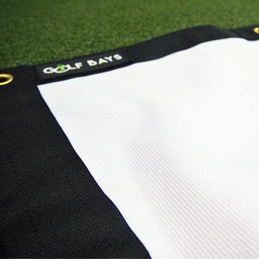 GolfBays USA reversible PRO golf simulator impact screen hanging against a wall, designed for indoor golf setups.